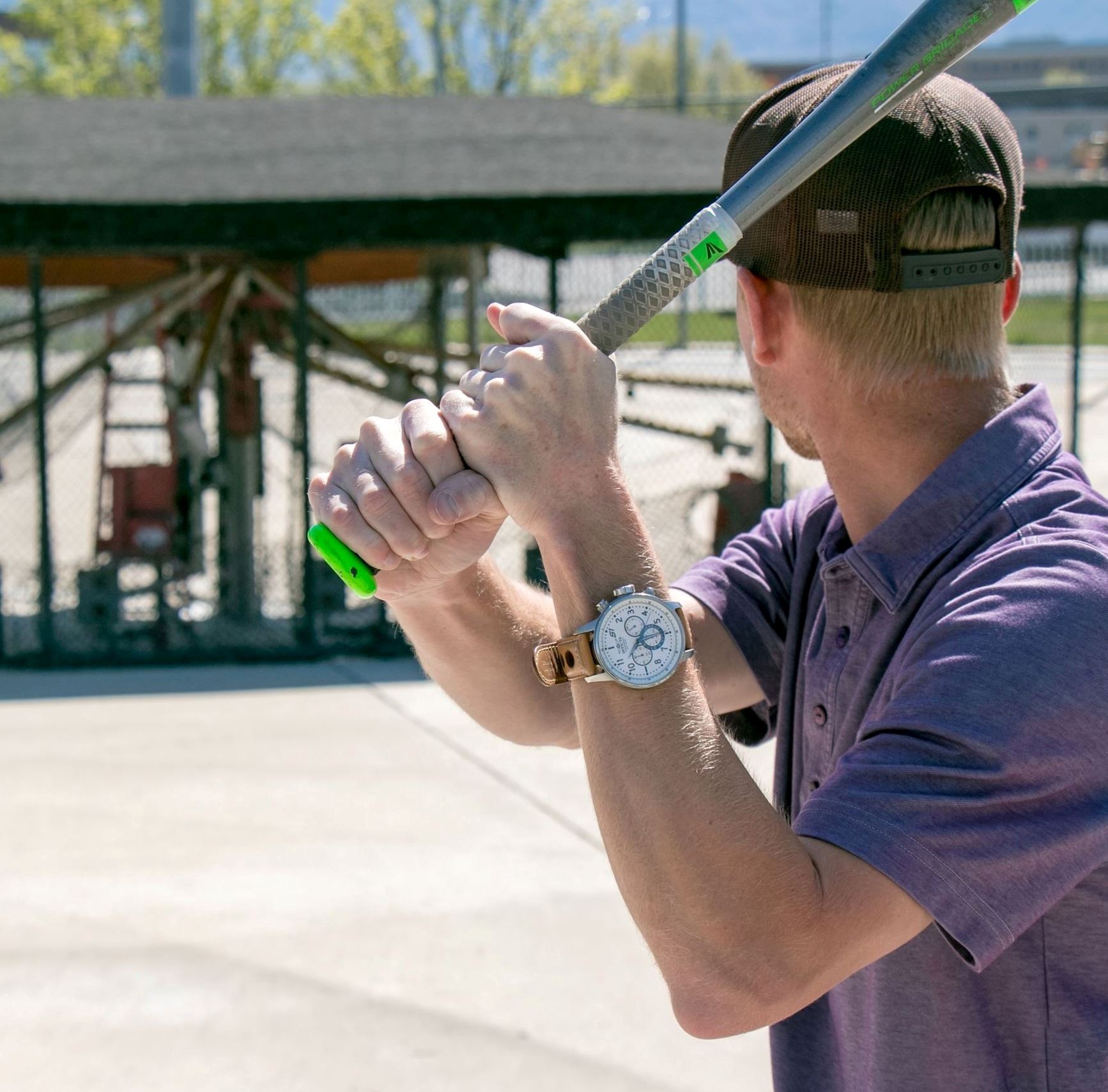 Man Standing with Bat at Batting Cages
