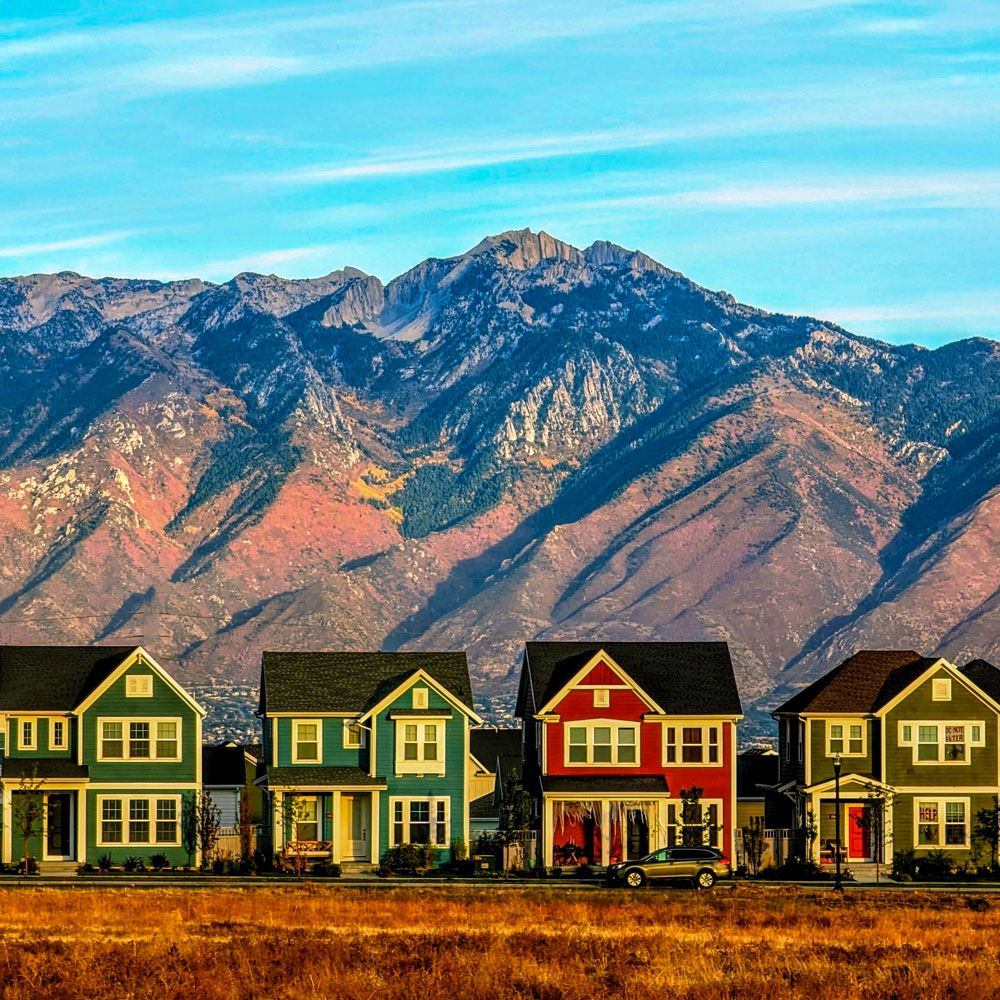 row of houses with the Wasatch mountains in the background